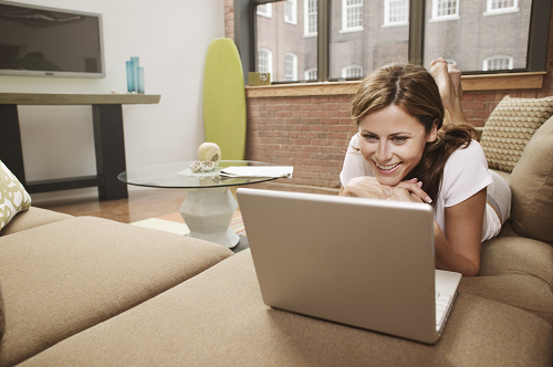 a person sitting at a table in front of a laptop